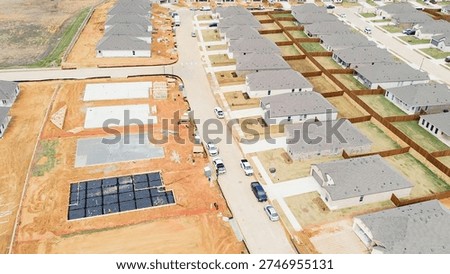 Construction staging pads, foundation work Highpointe, US-377, Blackjack Rd, trenching, plumbing lines, moisture barriers lots. Rebar grids, dark sheeting, graded soil, early build, Aubrey, TX. USA