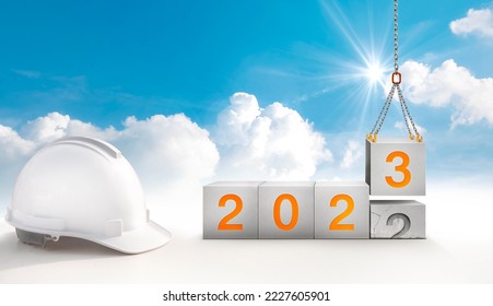 construction start working in the new year 2023. Success real estate, teamwork, and a healthy environment.Construction-crane lifting the cube and number 3 replace the year 2022 - Shutterstock ID 2227605901