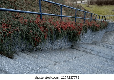 construction of a steep staircase by the stone wall car park with high durability even under heavy load galvanized steel floor grate and railings. gabion above him a wire fence. corridor, narrow - Shutterstock ID 2277237793