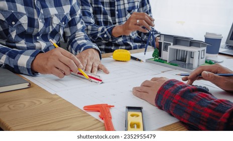 Construction and structural concept of engineer working at blueprints meeting for project working with partner in modeling and engineering tools in workplace, construction concept