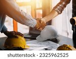 Construction and structure concept of Engineer or architect meeting for project working with partner and engineering tools on model building and blueprint in working site, contract for both companies.