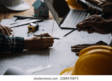 Construction and structure concept of Engineer or architect meeting for project working with partner and engineering tools on model building and blueprint in working site, contract for both companies.