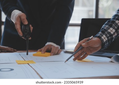 Construction and structure concept of Engineer or architect meeting for project working with partner and engineering tools on model building and blueprint in working site, contract for both companies.
