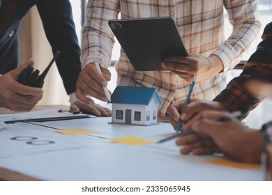 Construction and structure concept of Engineer or architect meeting for project working with partner and engineering tools on model building and blueprint in working site, contract for both companies.