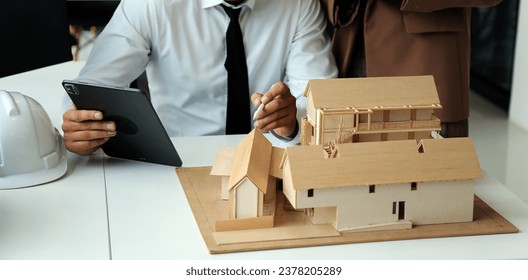 Construction and structure concept of Engineer or architect meeting for project working with partner and engineering tools on model building and blueprint in working site, contract for both companies. - Powered by Shutterstock - Get 15% off with code: PIKWIZARD15