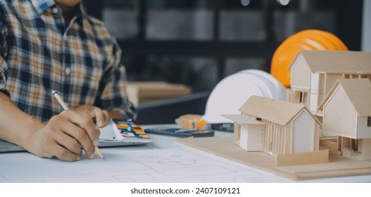 Construction and structure concept of Engineer or architect meeting for project working with partner and engineering tools on model building and blueprint in working site, contract for both companies.