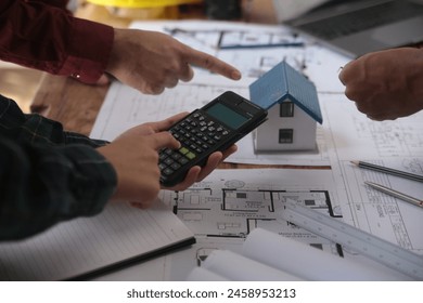 Construction and structure concept of Engineer or architect meeting for project working with partner and engineering tools on model building and blueprint in working site, contract for both companies.