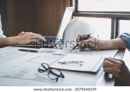 Construction and structure concept of Engineer or architect meeting for project working with partner and engineering tools on model building and blueprint in working site, contract for both companies.