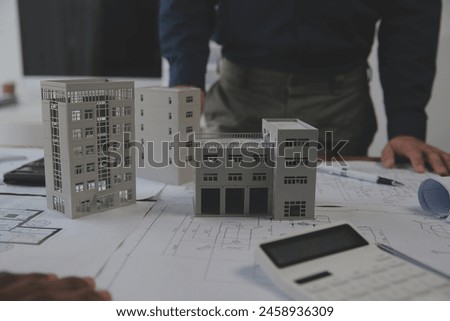 Construction and structure concept of Engineer or architect meeting for project working with partner and engineering tools on model building and blueprint in working site, contract for both companies.