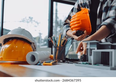 Construction and structure concept of engineer working drawing on blueprint meeting for project working with partner on model building and engineering tools in working site, construction concept.