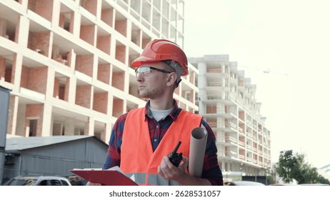 Construction superintendent posing for camera during development site inspection
