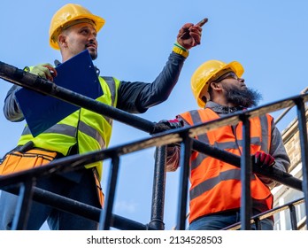 A construction supervisor inspecting the building work with a client.