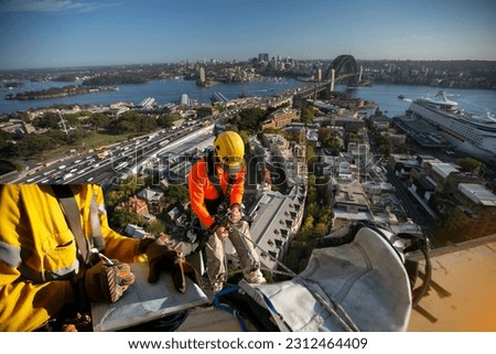 Construction supervisor wearing safety glove signing working at heights working permit on open field job site prior to starting high risk rope access construction Sydney CBD beautiful harbour bridge 