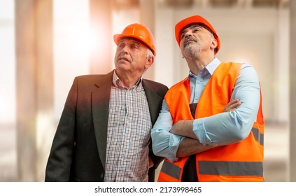 Construction Supervisor, Workers At A Construction Site. Managers Wearing Protective Workwear, Hard Hat Looking Up. Construction Workforce, Working Labor Man.