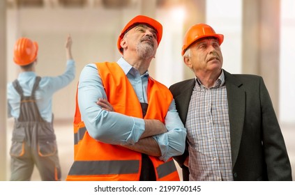 Construction Supervisor, Workers At A Construction Site. Managers Wearing Protective Workwear, Hard Hat Looking Up. Construction Workforce, Working Labor Man.