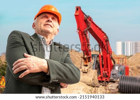 Construction supervisor, workers at a construction site. Managers wearing protective workwear, hard hat looking up, construction bulldozer, excavator. Construction workforce, working labor man.