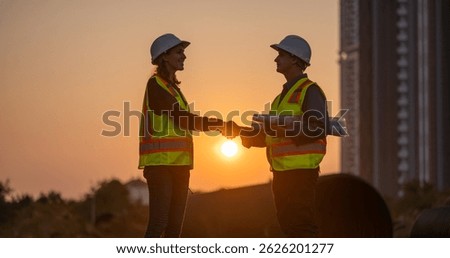 Construction surveyor or engineer working in pipe construction site for inspection detail of construction with heavy machinery excavator constructed hi-way road background.