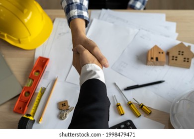 A Construction Team Leader Shakes Hands With A Home Builder After Agreeing A Contract To Work Together.