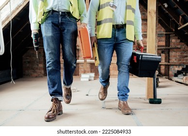 Construction, team and legs of engineers walking on the building site for home renovation project. People, construction worker teamwork and feet of men walking in industrial building for maintenance
