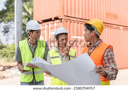 Construction team strategizing and problem-solving with blueprints at a busy project site