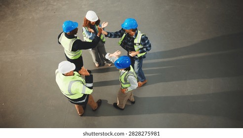 Construction, team and unity with high five in meeting or above for success, winning or mission. Top view, architect or group of contractors with touch or celebration for completion or done on space