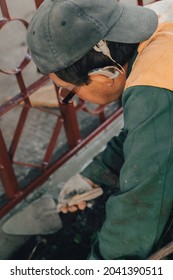 Construction Technicians With Hearing Aid Working With Cement Paving, Mix With Trowel At Side Work In Backyard. Cement Mortar Powder Put On Brick. Real Candid Farm Craftsman Worker Bricklaying.