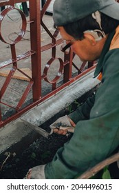 Construction Technicians With Hearing Aid Working With Cement Paving, Mix With Trowel At Side Work In Backyard. Cement Mortar Powder Put On Brick. Real Candid Farm Craftsman Worker Bricklaying.