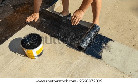 Construction techniques for waterproofing basement and foundations. Insulation material on the basement concrete wall. Waterproofing house foundation with spray on tar and roll waterproofing