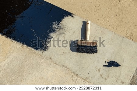 Construction techniques for waterproofing basement and foundations. Insulation material on the basement concrete wall. Waterproofing house foundation with spray on tar and roll waterproofing
