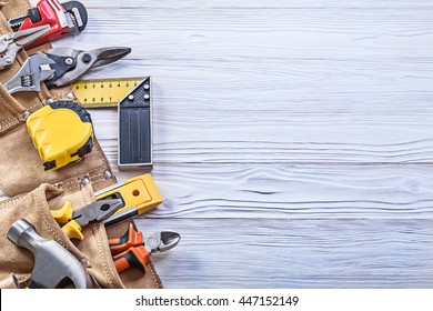 Construction Tooling In Leather Toolbelt On Wooden Board Copy Space Maintenance Concept.