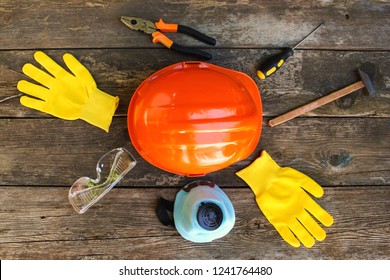     Construction tools and means of protection on an old wooden background. Top view. Flat lay.