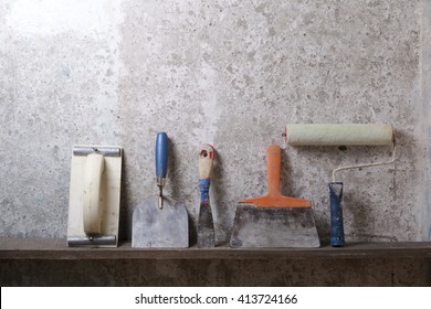 Construction Tools On Concrete Background. Copy Space For Text. Set Of Assorted Plaster Trowel Tools And Spatula . Top View