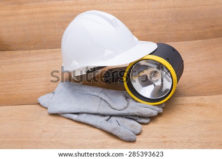 Construction tools on white background. Arrangement of hard hat, leather gloves and flashlight 