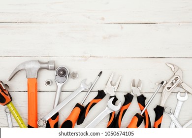 Construction tools on the white wooden background.