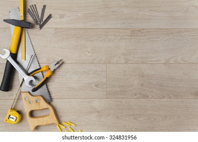 Construction tools on a wood background.