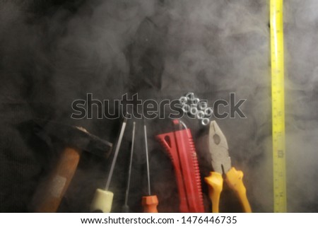 construction tools in smoke on a black background