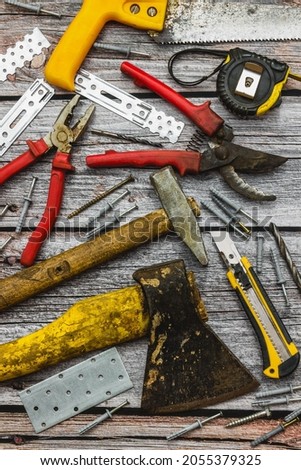 Construction tools for various types of work. Professional worker's wooden table. Home renovation, garden work. Home renovation, garden work. View from above. Place for text