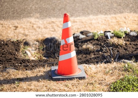 Construction traffic cones urging caution and compliance with regulations.