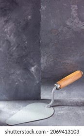 Construction Trowel Tool At Cement  Background. Mason Tools On Concrete Wall