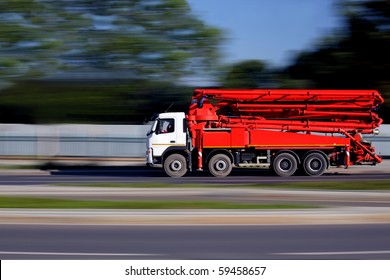 Construction truck with concrete pump machinery on  way