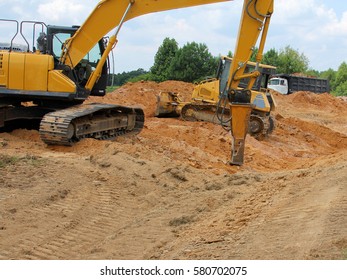 Construction Vehicle Breaking Through Rock - Photograph Of A Construction Vehicle Working On Breaking Through A Difficult Rocky Area. 