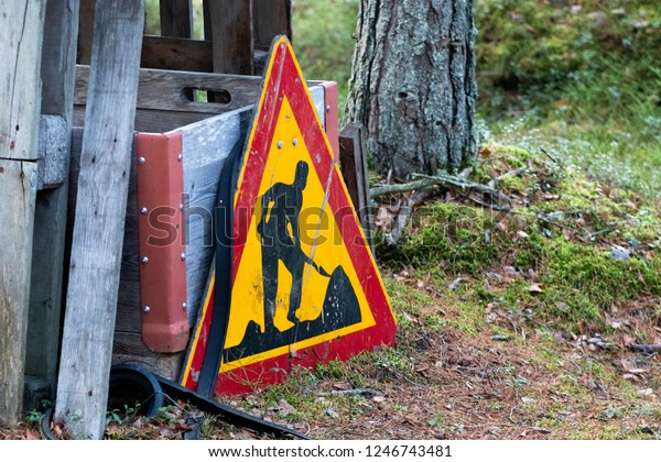 Construction warning sign in\
woods