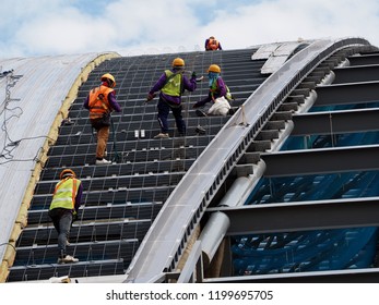 Construction Wiorker Roofing Metal Sheet On Roof Of Factory Warehouse And Wearing Safety Harness Hemet
Working On High Places