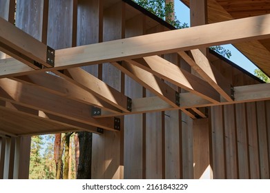 Construction of a wooden beam in interior decoration with metal fasteners in architecture, a design element of the construction of the facade of the building
