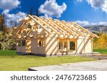 Construction wooden house. Erection of cottage. House frame made of planks. Unfinished building. Country house under construction. Erection of mansion in nature. Construction using frame technology