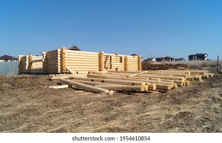 Construction of a wooden house on a sunny day in spring. New log house against the blue sky