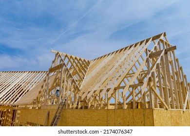Construction of a wooden roof beam house from an aerial top view