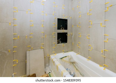 Construction work installing ceramic tile on reconstruction of bathroom during or renovation