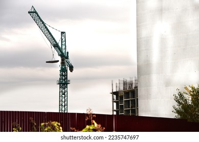 Construction work iws underway on a high-rise multi-storey building with a crane