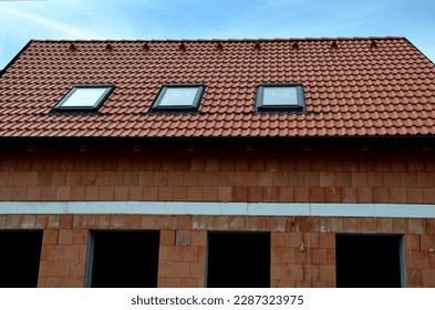 construction work on a house made of modern insulating bricks. roof windows, new housing. Windows openings, price of masonry. weekly companies, quality of work, companies